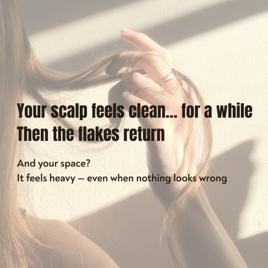 Person touching scalp showing dandruff and buildup issue before using essential oil