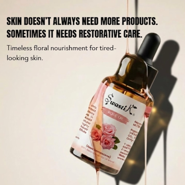 Swastik Rose Essential Oil bottle with soft pink floral label styled in warm luxury lighting for skin nourishment and radiant skincare rituals.